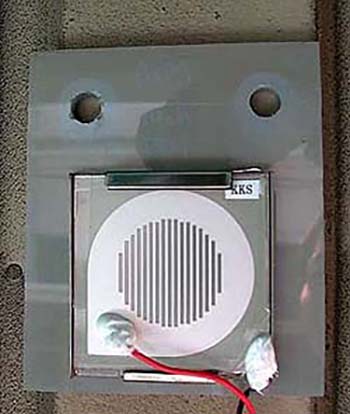 Enlarged view of ACM Sensor installed on wall surface under eaves